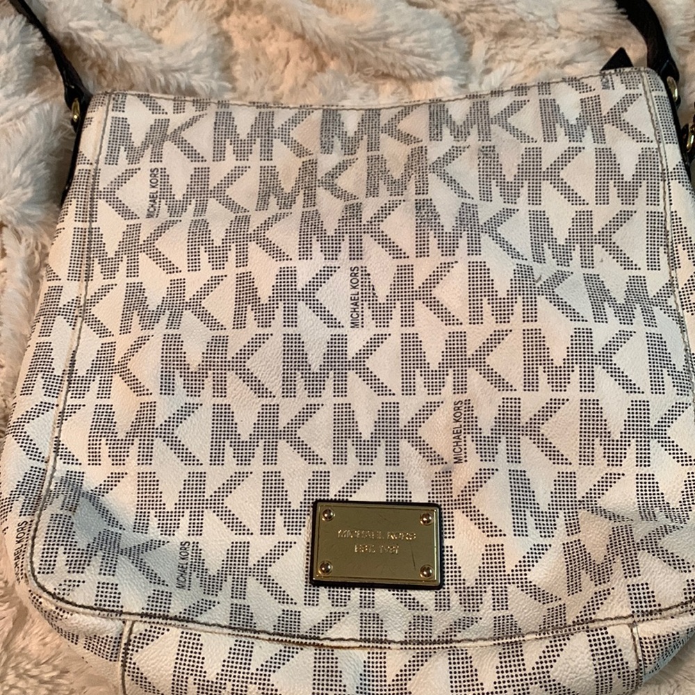 Blue and cream colored MK crossbody purse